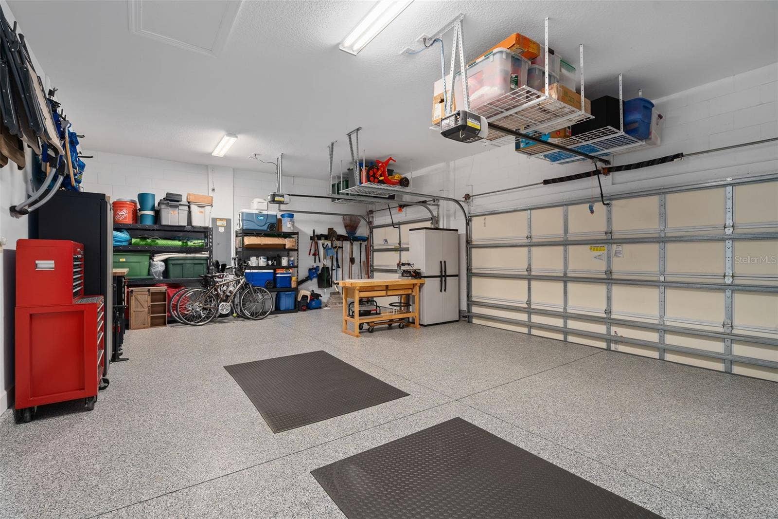 1279 ZEEK RIDGE STREET, Clermont, FL 34715 This full 3 car garage with a "Shark Coating" floor, Insulated garage doors and ceiling storage.