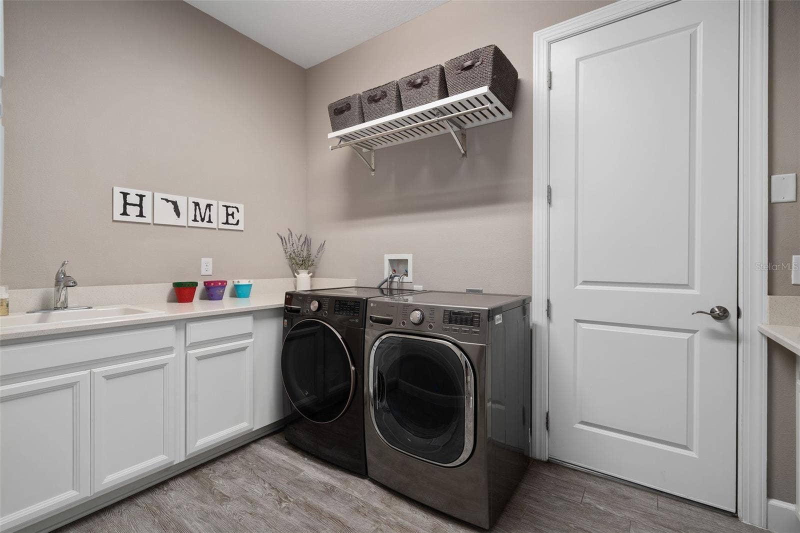 1279 ZEEK RIDGE STREET, Clermont, FL 34715 The laundry room has a sink and a drop area for your convenience.