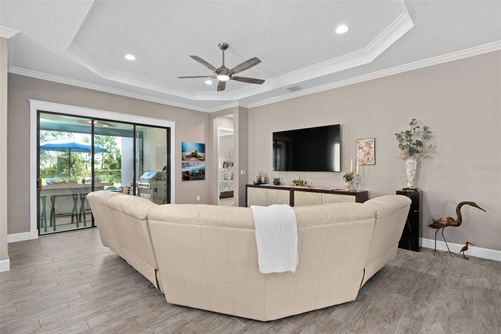 1279 ZEEK RIDGE STREET, Clermont, FL 34715 Great room with a view of the screened lanai and the rear yard.
