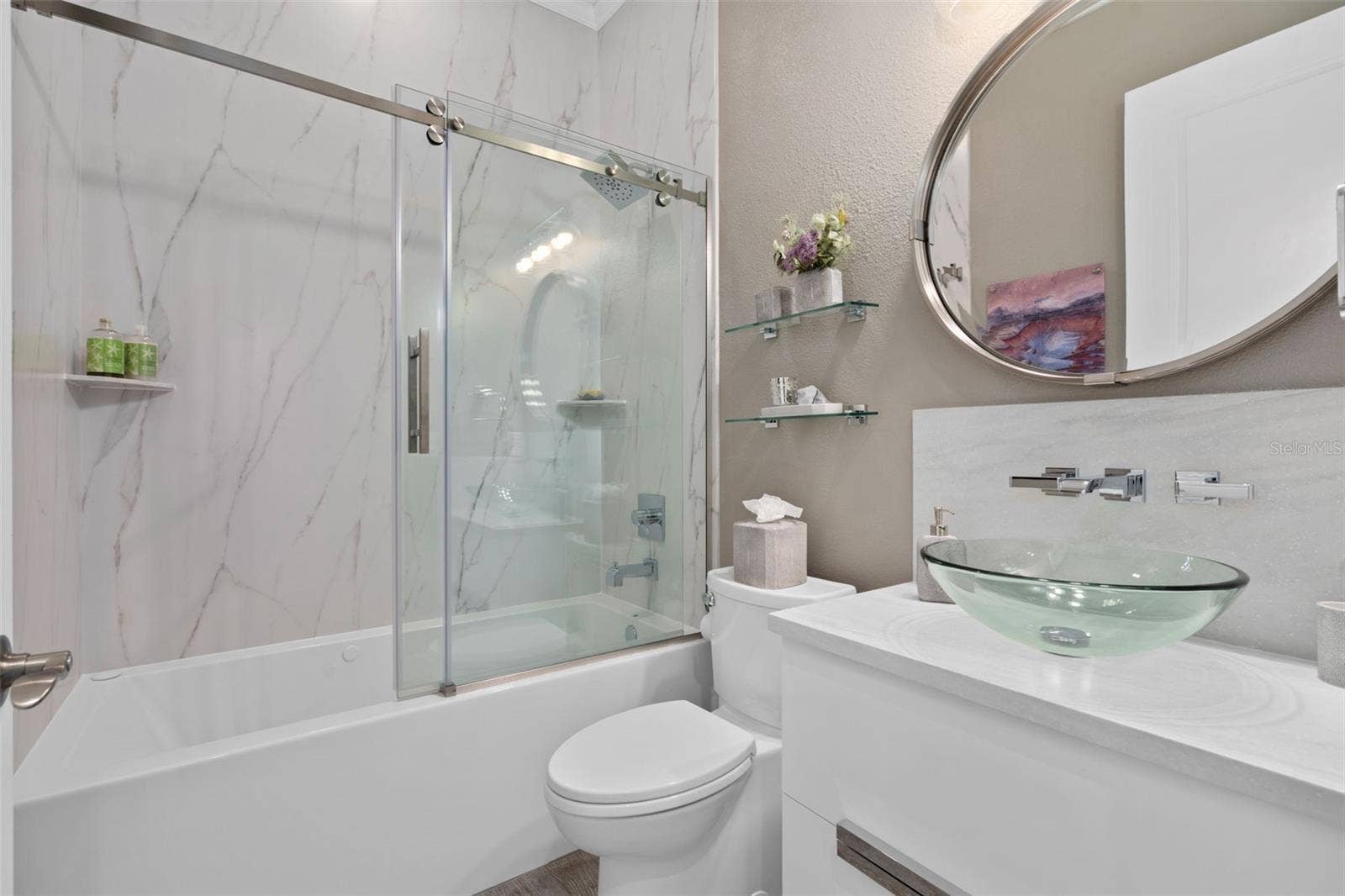 1279 ZEEK RIDGE STREET, Clermont, FL 34715 The Remodeled bathroom 3 is adjacent to Bedroom 3. The jetted tub also has bubblers in the base and is longer than a typical tub for your comfort. A stunning vanity, vessel sink and accessories adds the finishing touches.