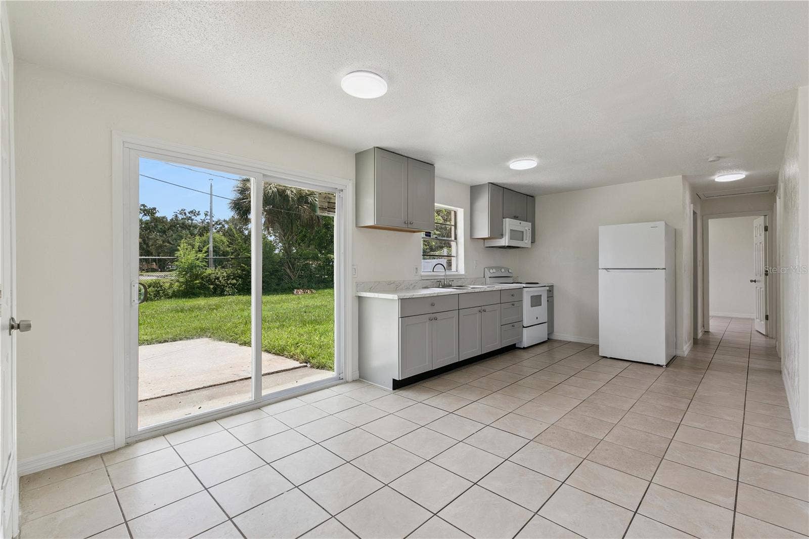 875 LOOMIS AVENUE, Daytona Beach, FL 32114 Kitchen with Patio Access