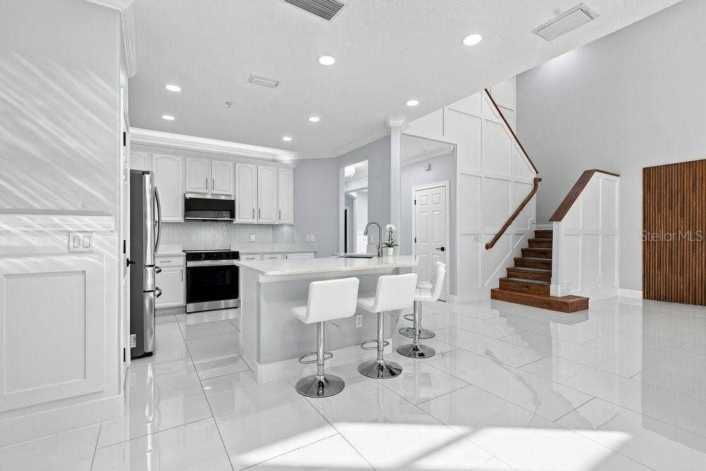 7149 REGINA WAY, Orlando, FL 32819 Porcelain tile throughout the first floor