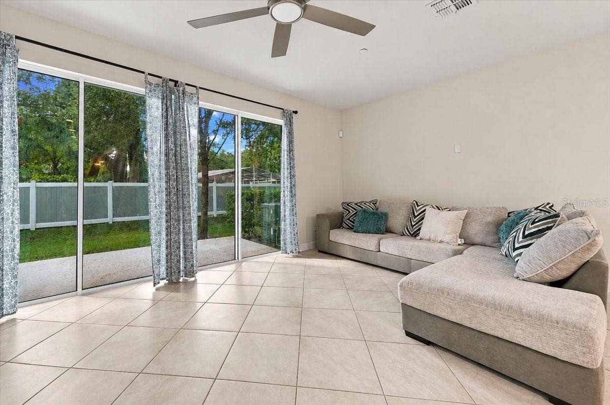 Spacious living room with sliding glass doors opening to the backyard