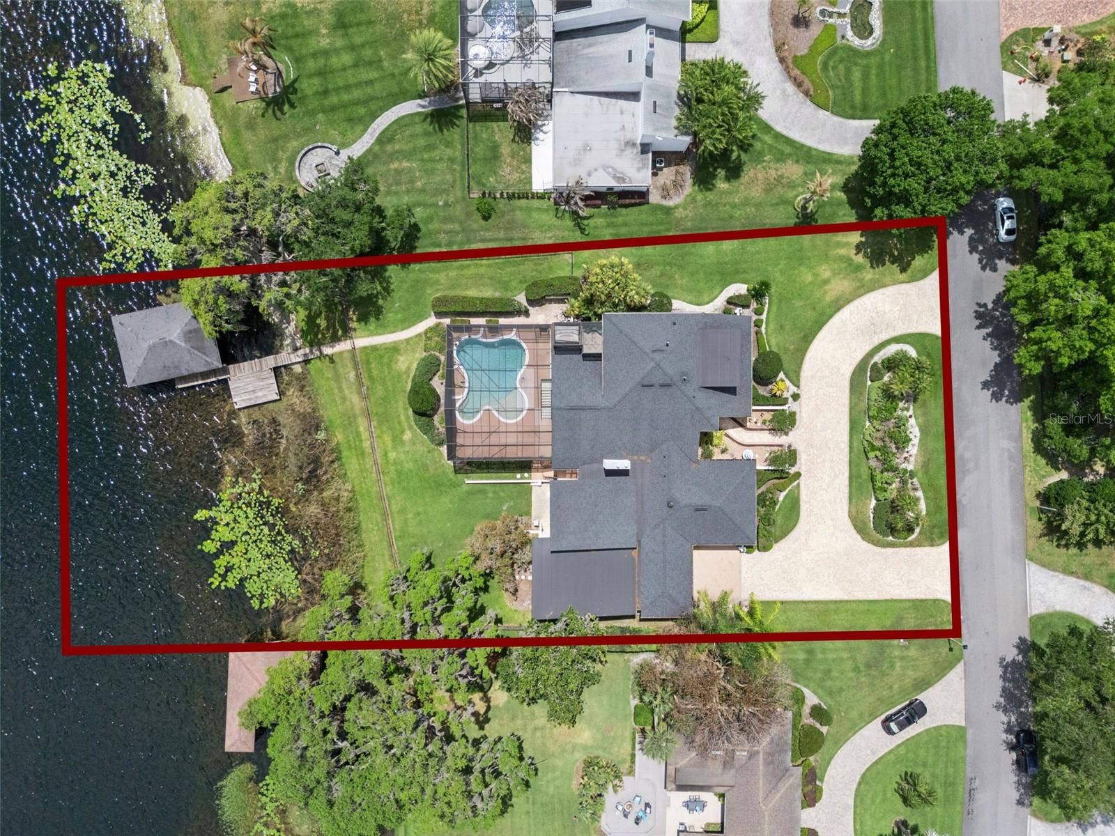 4301 DOWN POINT LANE, Windermere, FL 34786 Outdoor features include a screened pool, covered entertaining area, fenced yard.