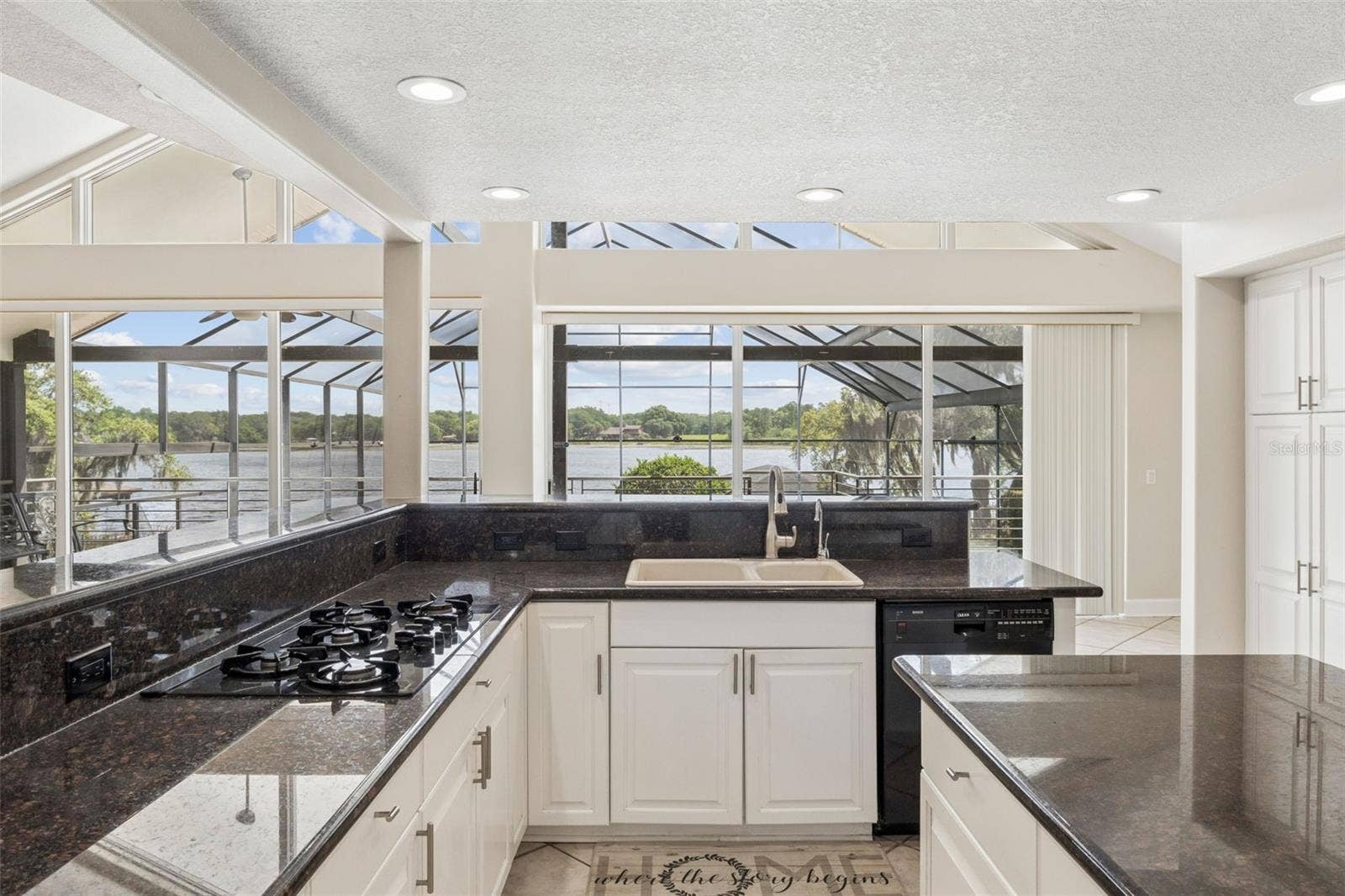 4301 DOWN POINT LANE, Windermere, FL 34786 Kitchen with panoramic lake views, perfectly positioned to overlook the lanai and pool deck.