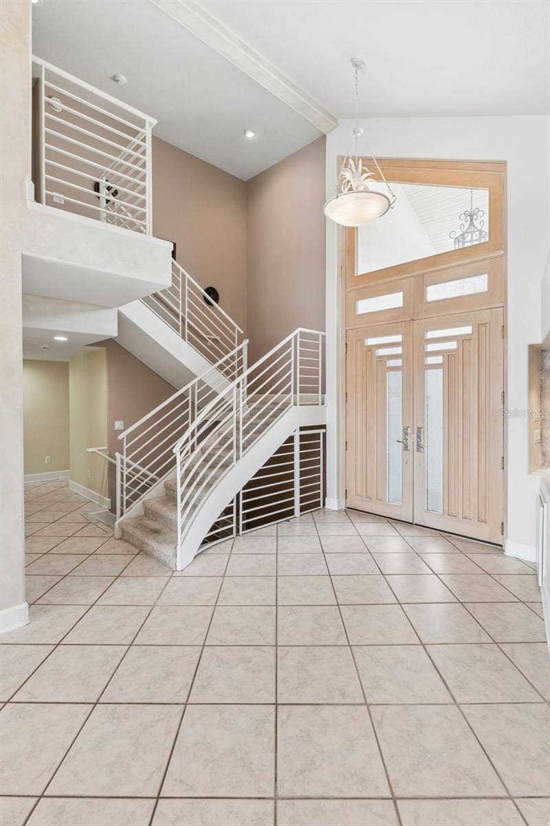 4301 DOWN POINT LANE, Windermere, FL 34786 Staircase leading to the private upstairs primary suite, office/loft with lake-views.