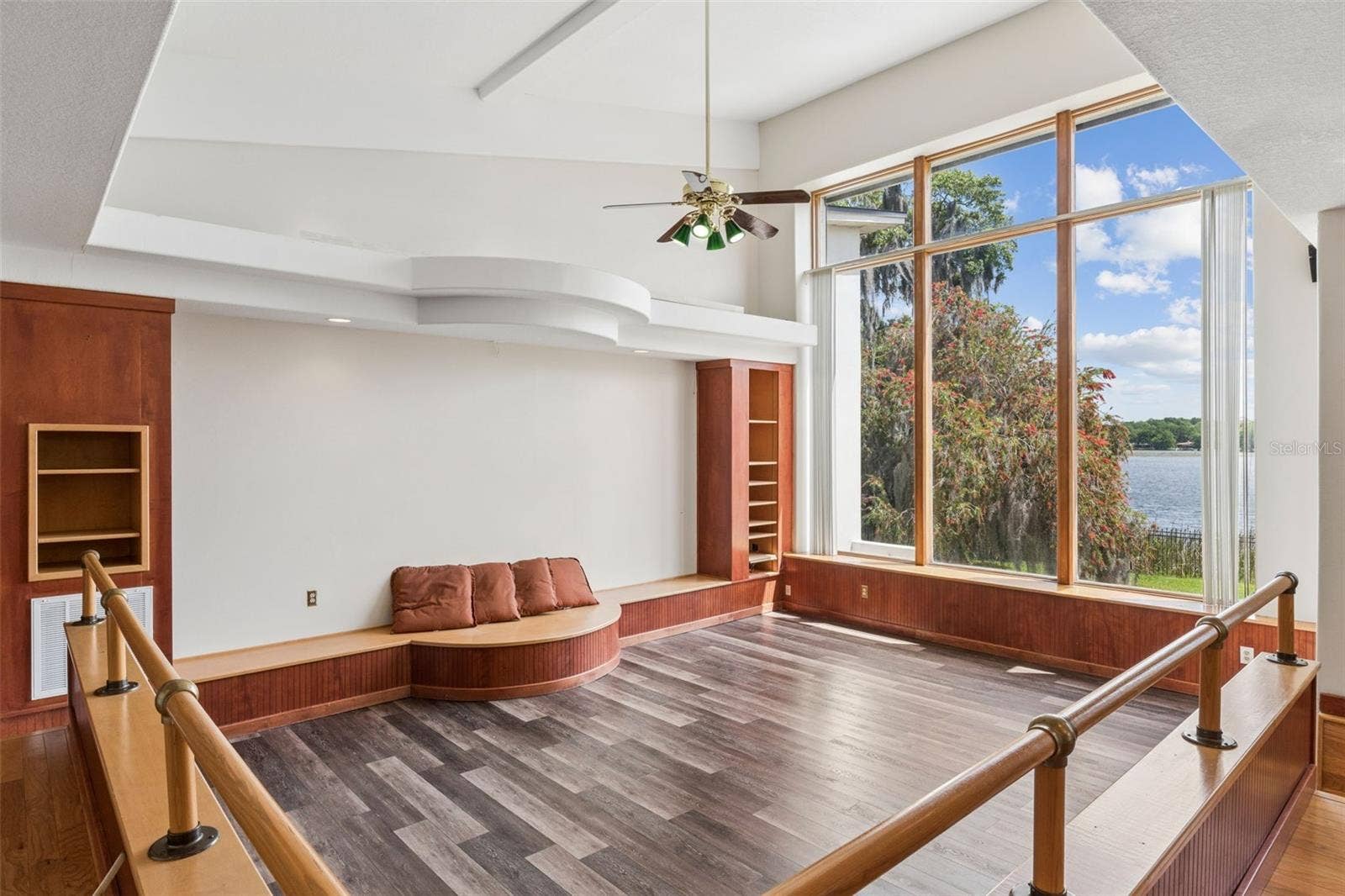 4301 DOWN POINT LANE, Windermere, FL 34786 Sunken great room with soaring ceilings, custom built-ins, and floor-to-ceiling windows framing stunning lake views.