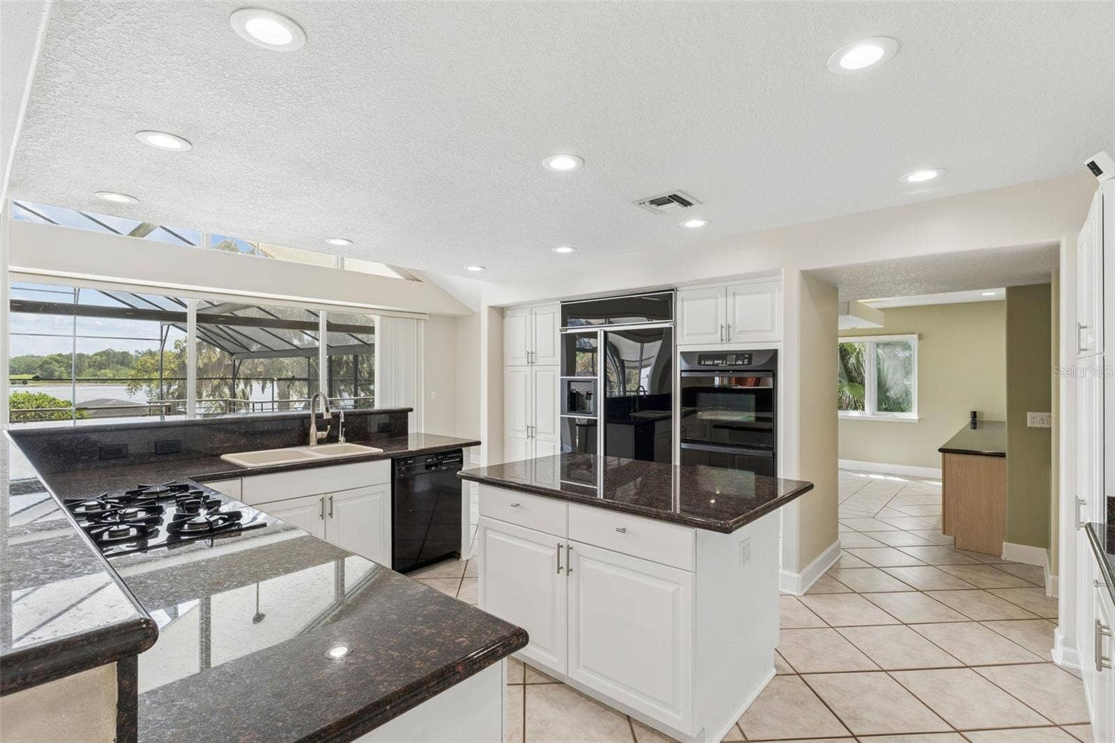 4301 DOWN POINT LANE, Windermere, FL 34786 Spacious kitchen with lake views, center island, and seamless flow into the dining room.