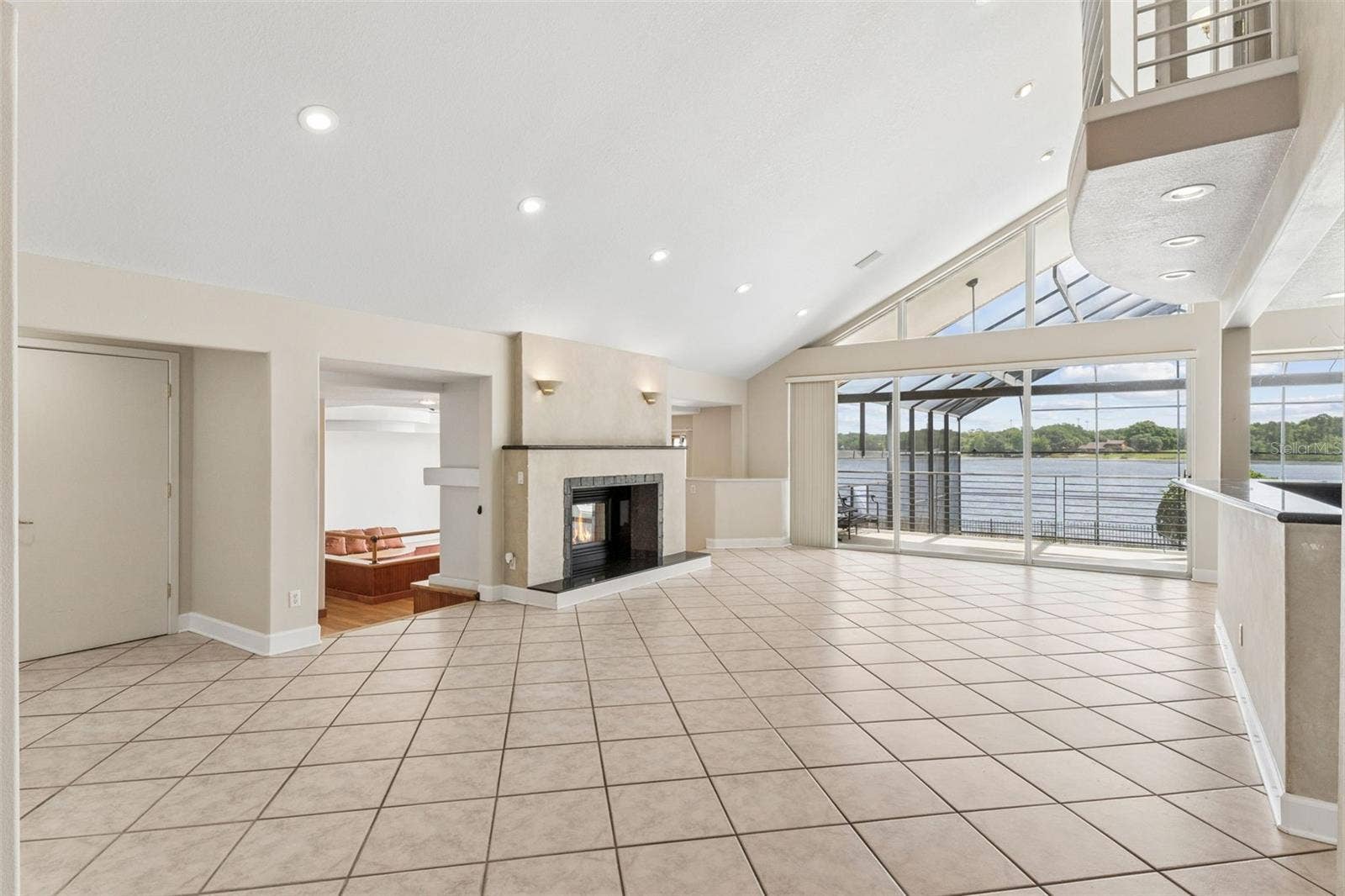 4301 DOWN POINT LANE, Windermere, FL 34786 Living Room with fireplace overlooking the formal dining room / great room.
