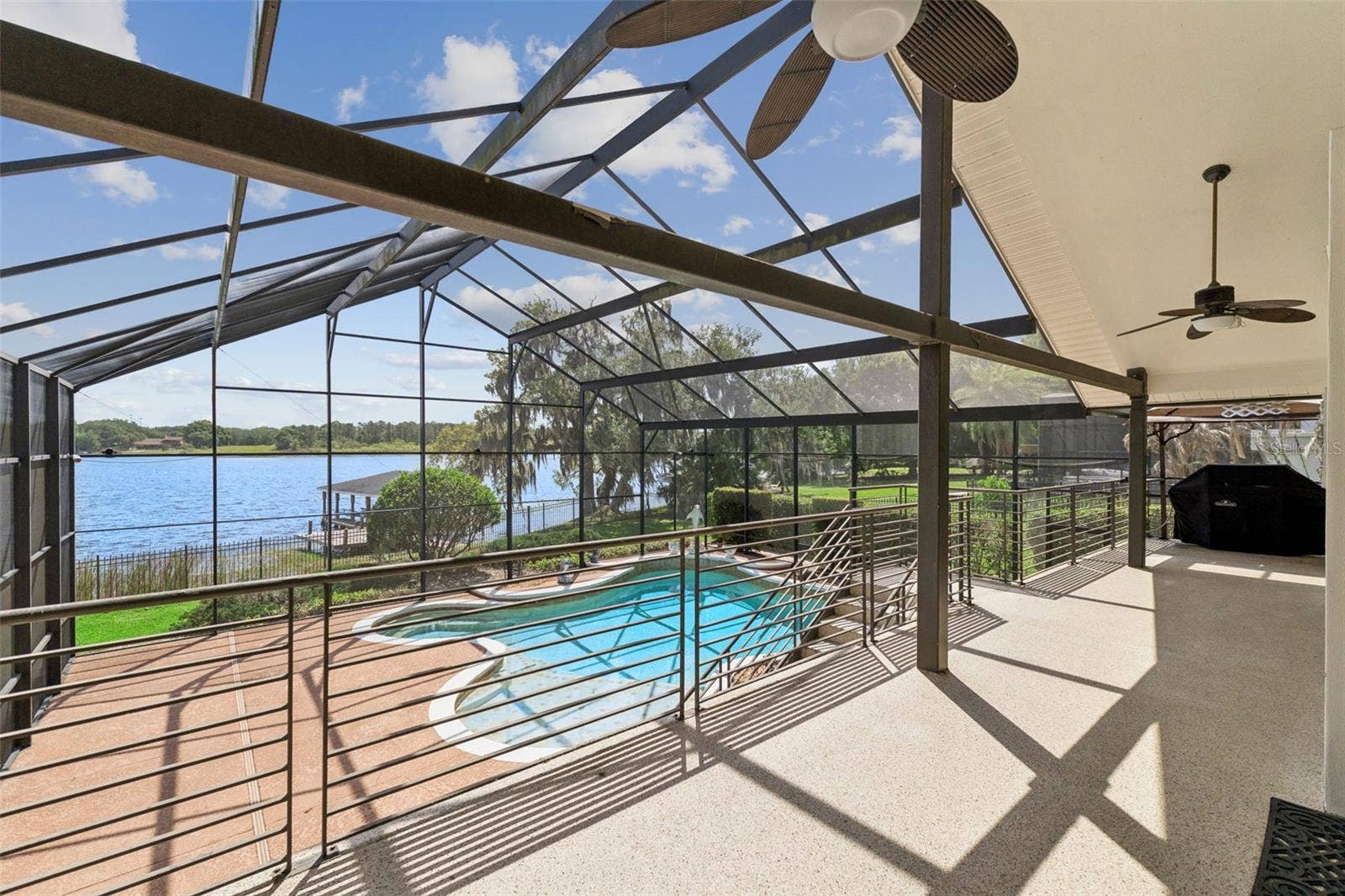 4301 DOWN POINT LANE, Windermere, FL 34786 Outdoor features include a screened pool, covered entertaining area, fenced yard.