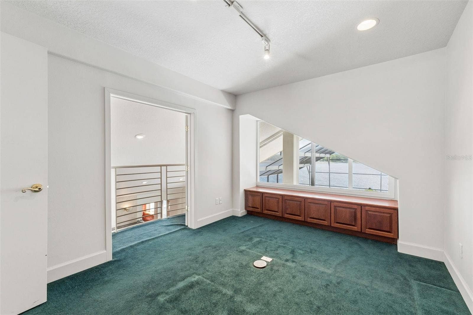 4301 DOWN POINT LANE, Windermere, FL 34786 Loft office with lake views and a balcony overlook to the living room below.