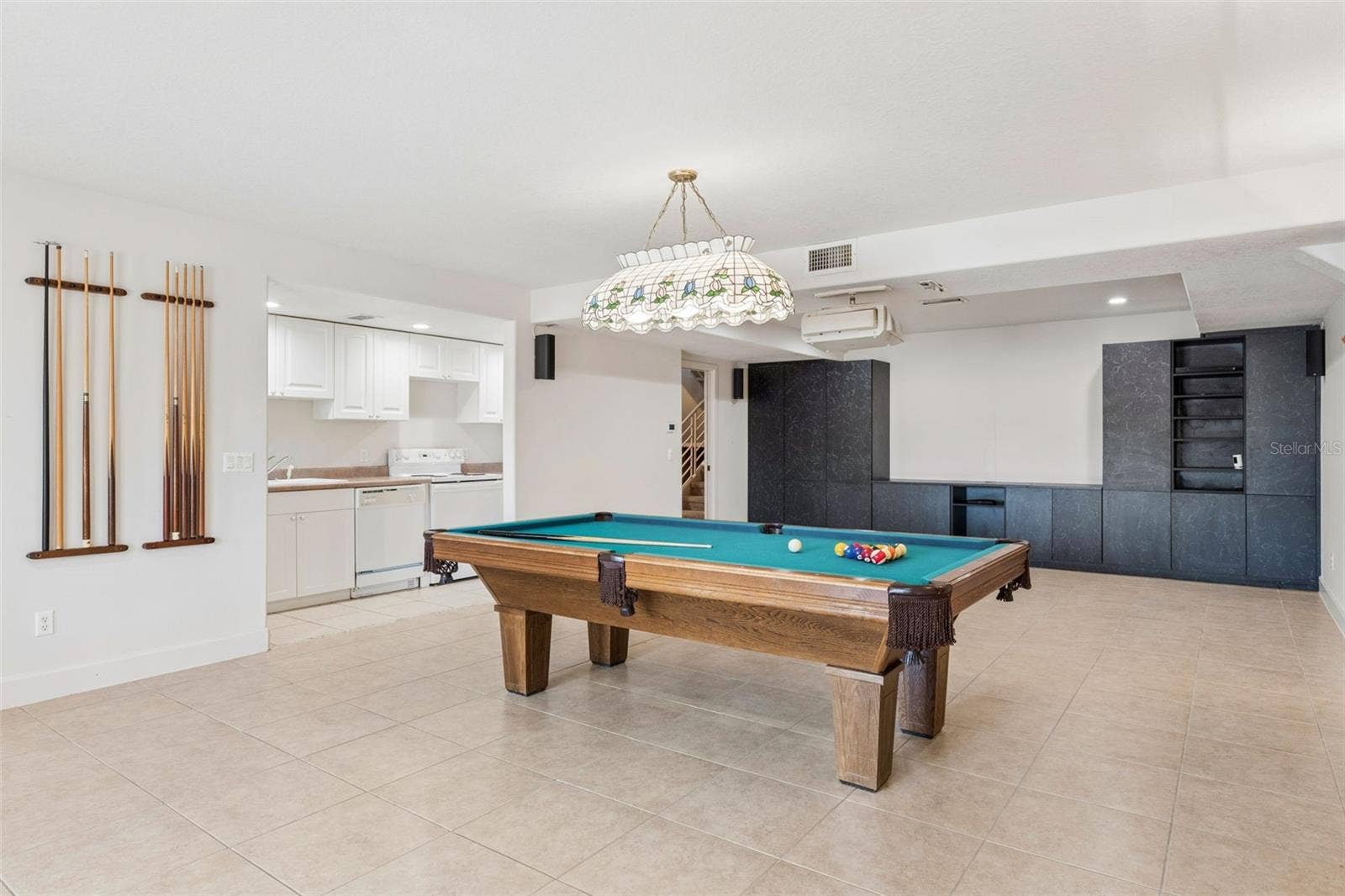 4301 DOWN POINT LANE, Windermere, FL 34786 Full-size basement living room with kitchenette, offering separate living quarters with a bedroom and full bath leading to the pool deck.