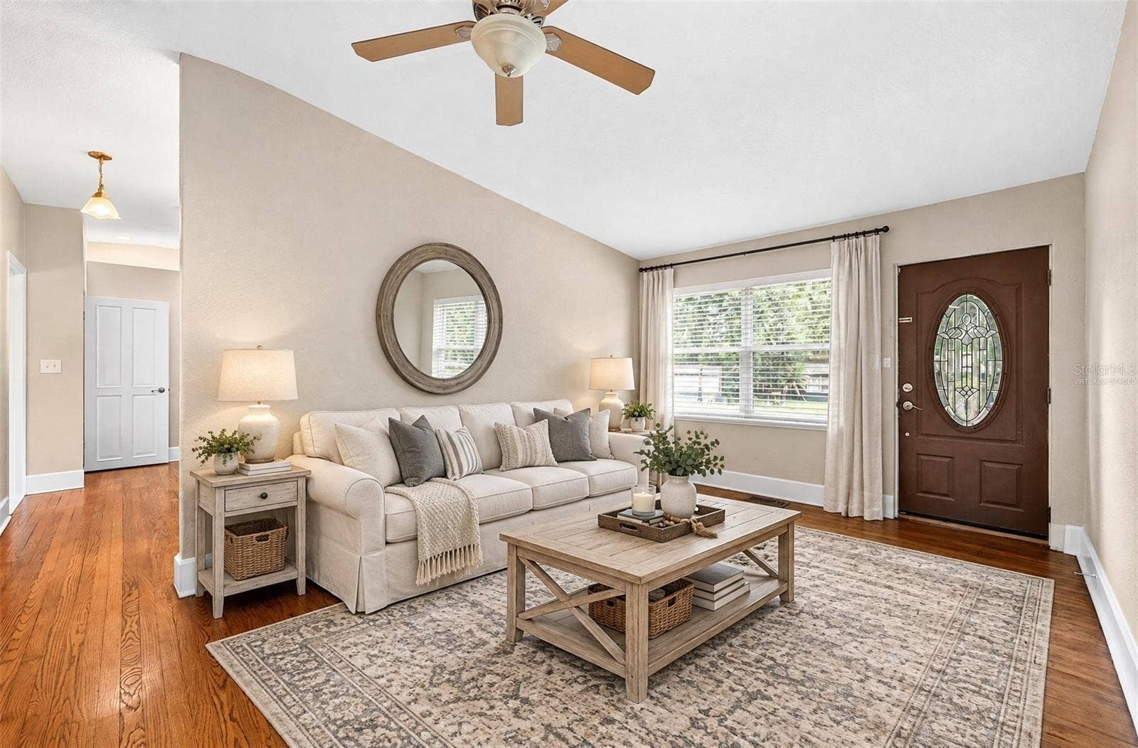 Formal living at the front of the home flows into the updated kitchen. Virtually Staged.