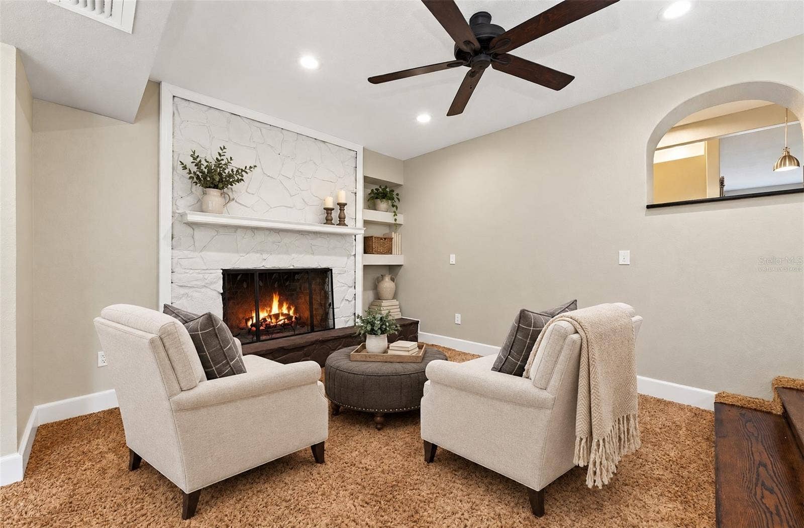 The first area of the family room features a fireplace feature wall. Virtually Staged.