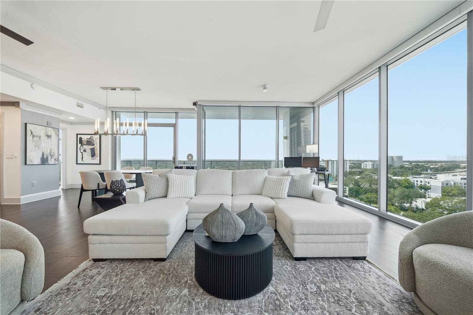 260 S OSCEOLA AVENUE, #1406, Orlando, FL 32801 Living Room | Downtown Orlandos layered skyline becomes the backdrop to the main living space