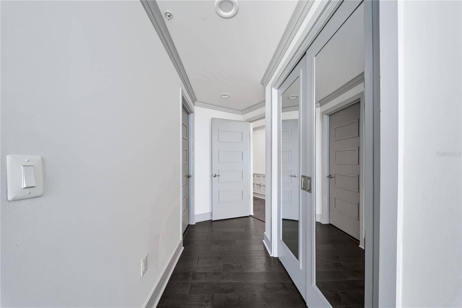 260 S OSCEOLA AVENUE, #1406, Orlando, FL 32801 PRIMARY BEDROOM HALL / SECOND CLOSET. Mirror covered double doors has second closet in bedroom hall.