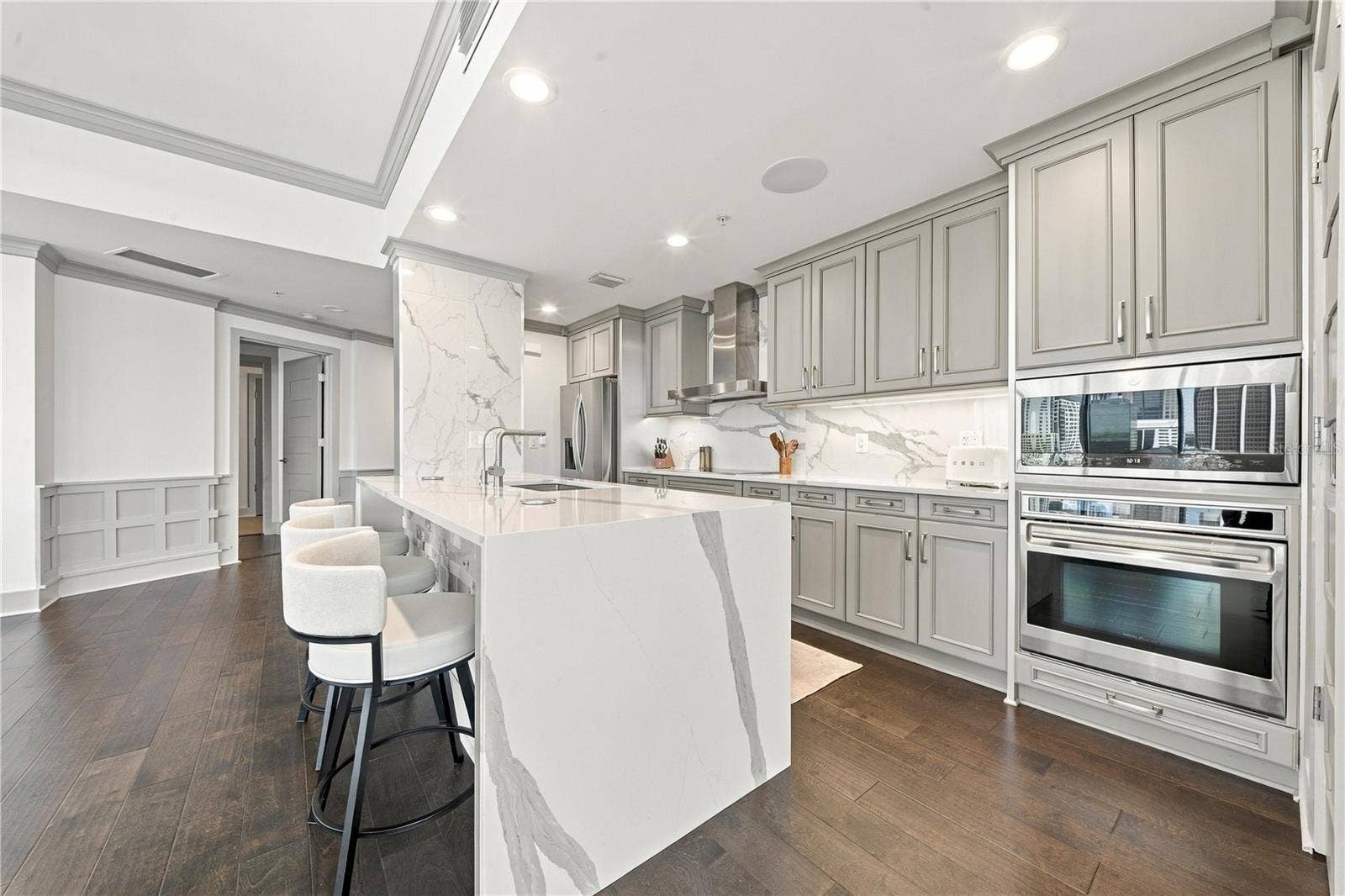 260 S OSCEOLA AVENUE, #1406, Orlando, FL 32801 Kitchen | Quartzite countertops and full-height slab backsplash pair with streamlined cabinetry