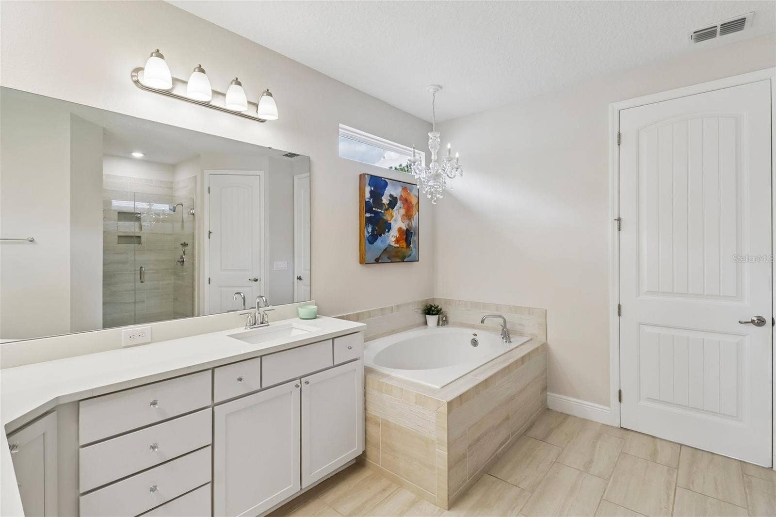 1257 WADING WATERS CIRCLE, Winter Park, FL 32792 Upstairs primary bath with dual vanities, separate tub & glass enclosed shower