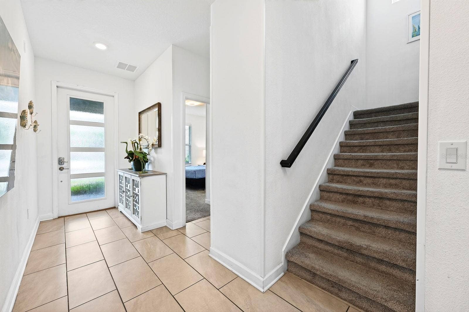 1045 LEADER STREET, Davenport, FL 33896 A brick paver driveway leads to the attached 1-car garage, beautifully accented with STONE FACING, while a stylish 4-LITE GLASS-PANELED FRONT DOOR welcomes you inside.
