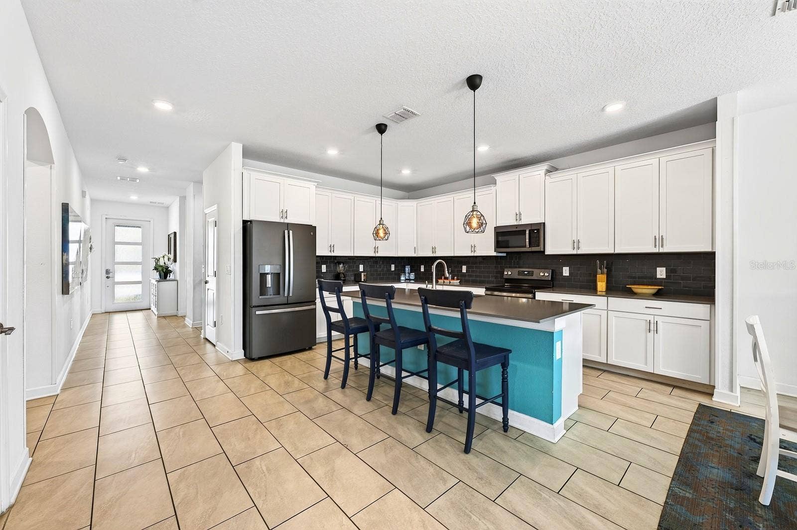 1045 LEADER STREET, Davenport, FL 33896 A generous center island offers extra prep space and room for counter-height seating.