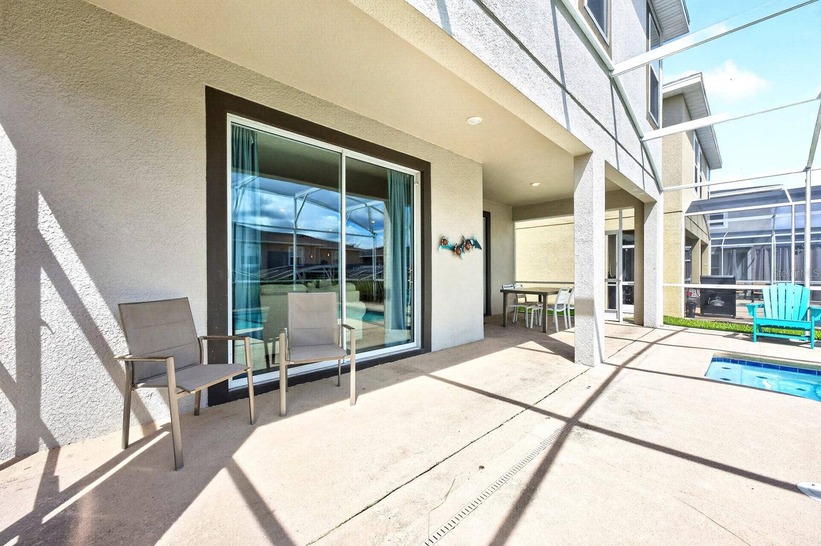 1045 LEADER STREET, Davenport, FL 33896 Sliding glass doors lead to your COVERED PATIO and PRIVATE POOL, all enclosed within a SCREENED LANAI.