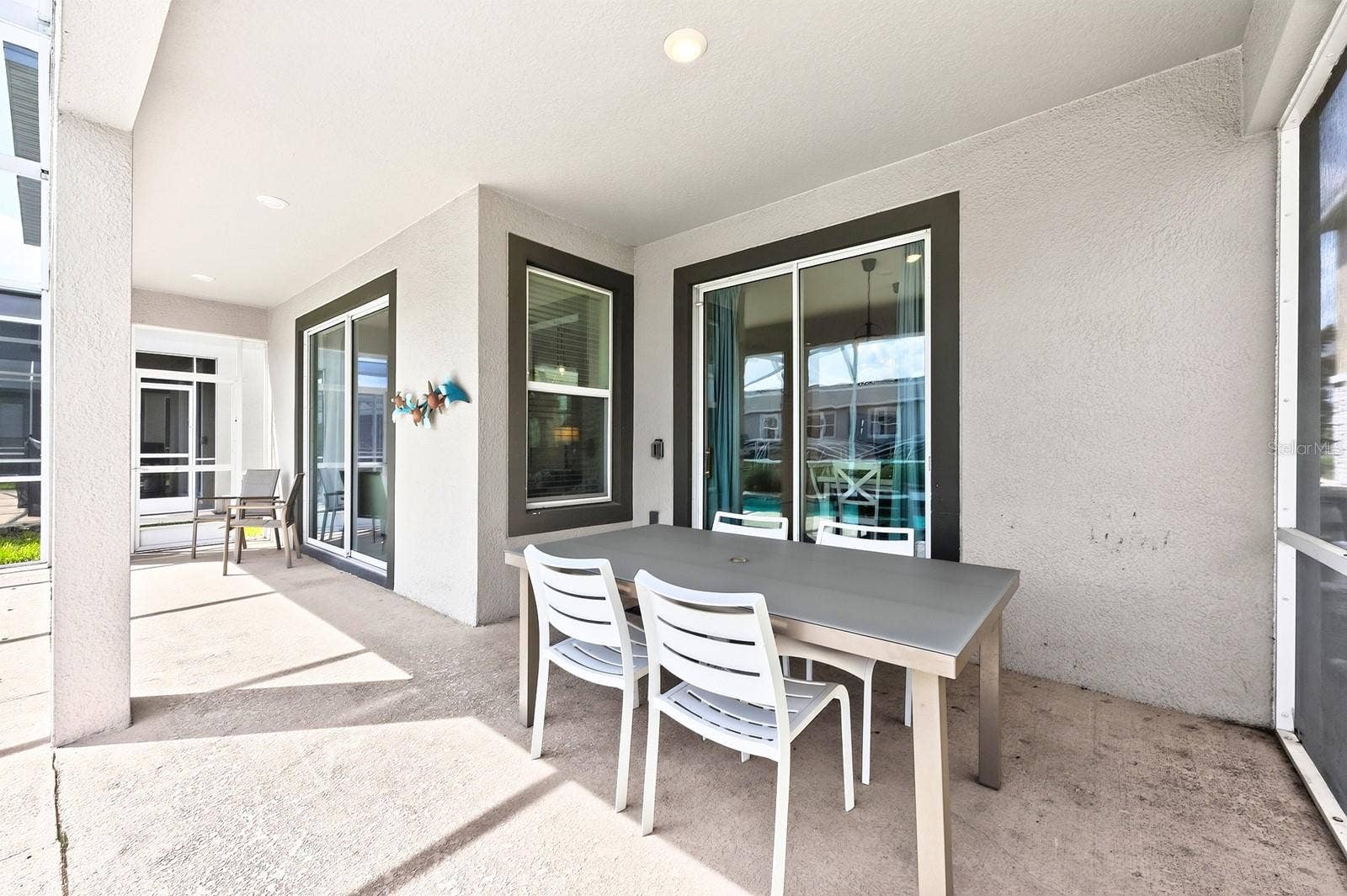 1045 LEADER STREET, Davenport, FL 33896 Sliding glass doors lead to your COVERED PATIO and PRIVATE POOL, all enclosed within a SCREENED LANAI.