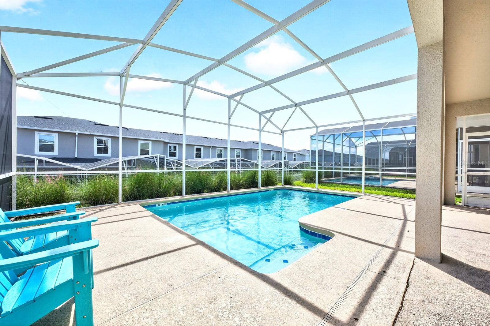 1045 LEADER STREET, Davenport, FL 33896 Outside, the PRIVATE POOL and covered patio under the SCREENED LANAI, create the perfect place to unwind after a day exploring Central Florida's attractions.