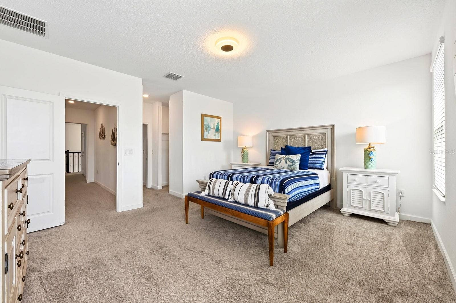 1045 LEADER STREET, Davenport, FL 33896 The generous PRIMARY SUITE is filled with NATURAL LIGHT and offers a WALK-IN CLOSET and private en-suite bath.