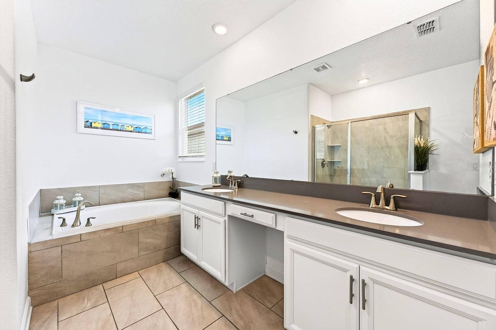 1045 LEADER STREET, Davenport, FL 33896 The Primary private en-suite bath boasts dual sinks, a GARDEN TUB, step-in shower, and private water closet.