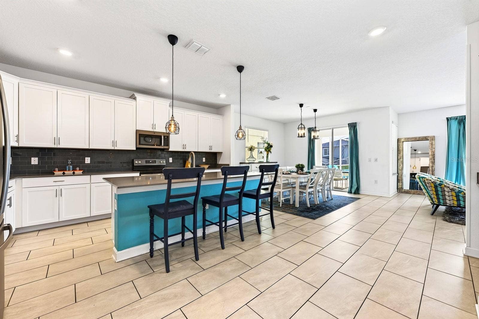 1045 LEADER STREET, Davenport, FL 33896 The main floor was designed for effortless gathering, with the Kitchen, Dining Area and Living Room flowing together in a bright OPEN CONCEPT layout.