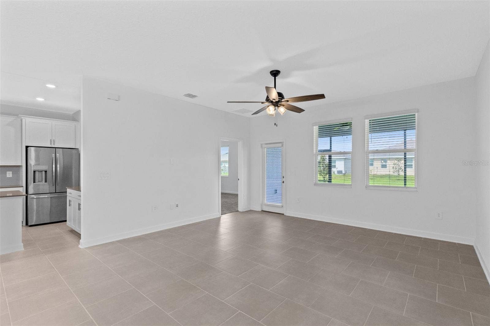 1874 FLOURISH AVENUE, Kissimmee, FL 34744 Dining room overlooking kitchen and living room.