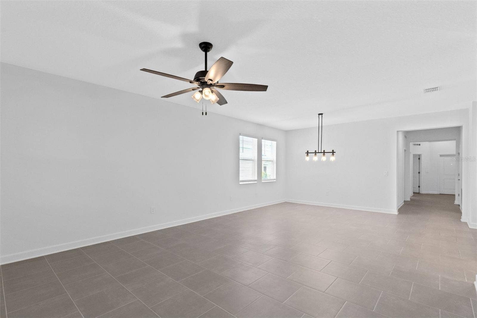 1874 FLOURISH AVENUE, Kissimmee, FL 34744 The dining and living spaces flow together beautifully, creating plenty of room for both everyday living and entertaining.