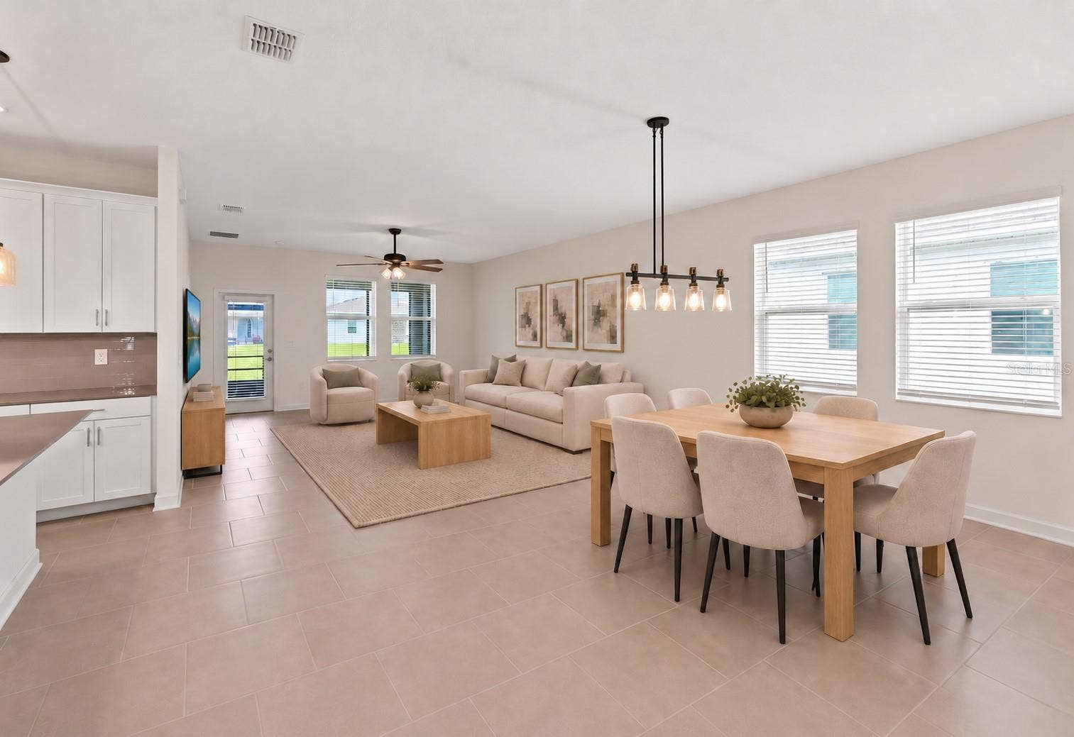1874 FLOURISH AVENUE, Kissimmee, FL 34744 The open kitchen, dining and living spaces flow together beautifully, creating plenty of room for both everyday living and entertaining.