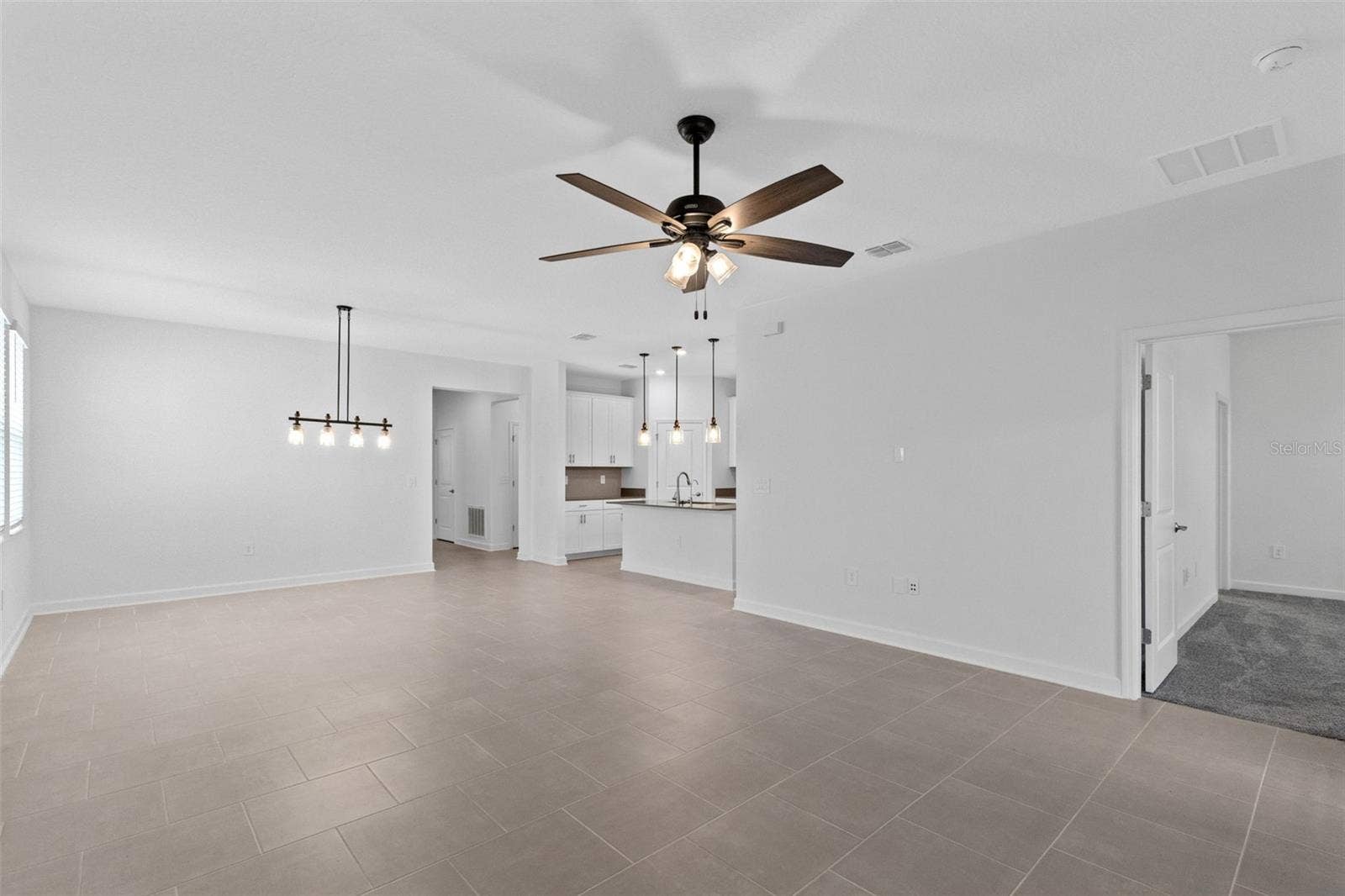 1874 FLOURISH AVENUE, Kissimmee, FL 34744 The open kitchen, dining and living spaces flow together beautifully, creating plenty of room for both everyday living and entertaining.
