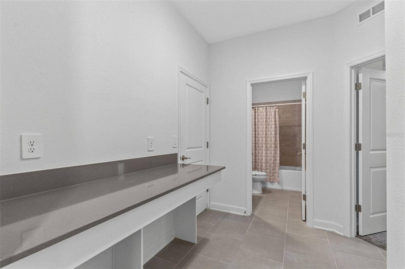 1874 FLOURISH AVENUE, Kissimmee, FL 34744 A built in desk and drop zone near the garage provide a dedicated place for homework, organization or working from home.