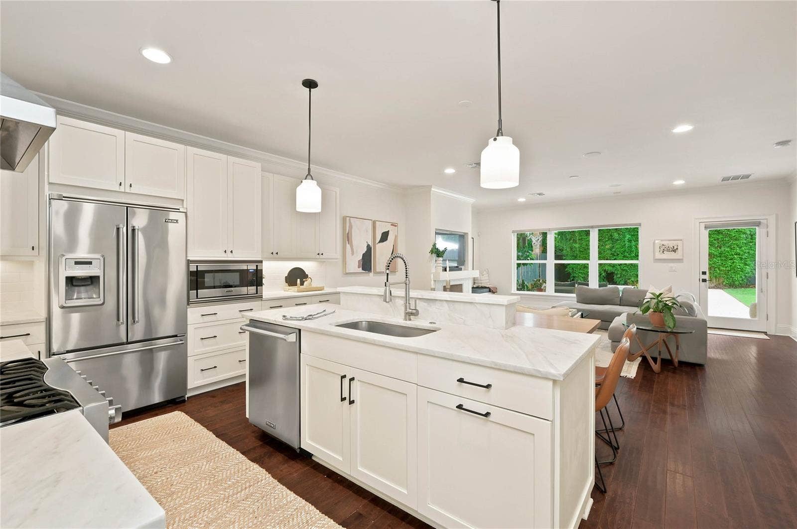 1707 ASHER LANE, Orlando, FL 32803 Sophisticated open Kitchen with marble countertops and white cabinetry