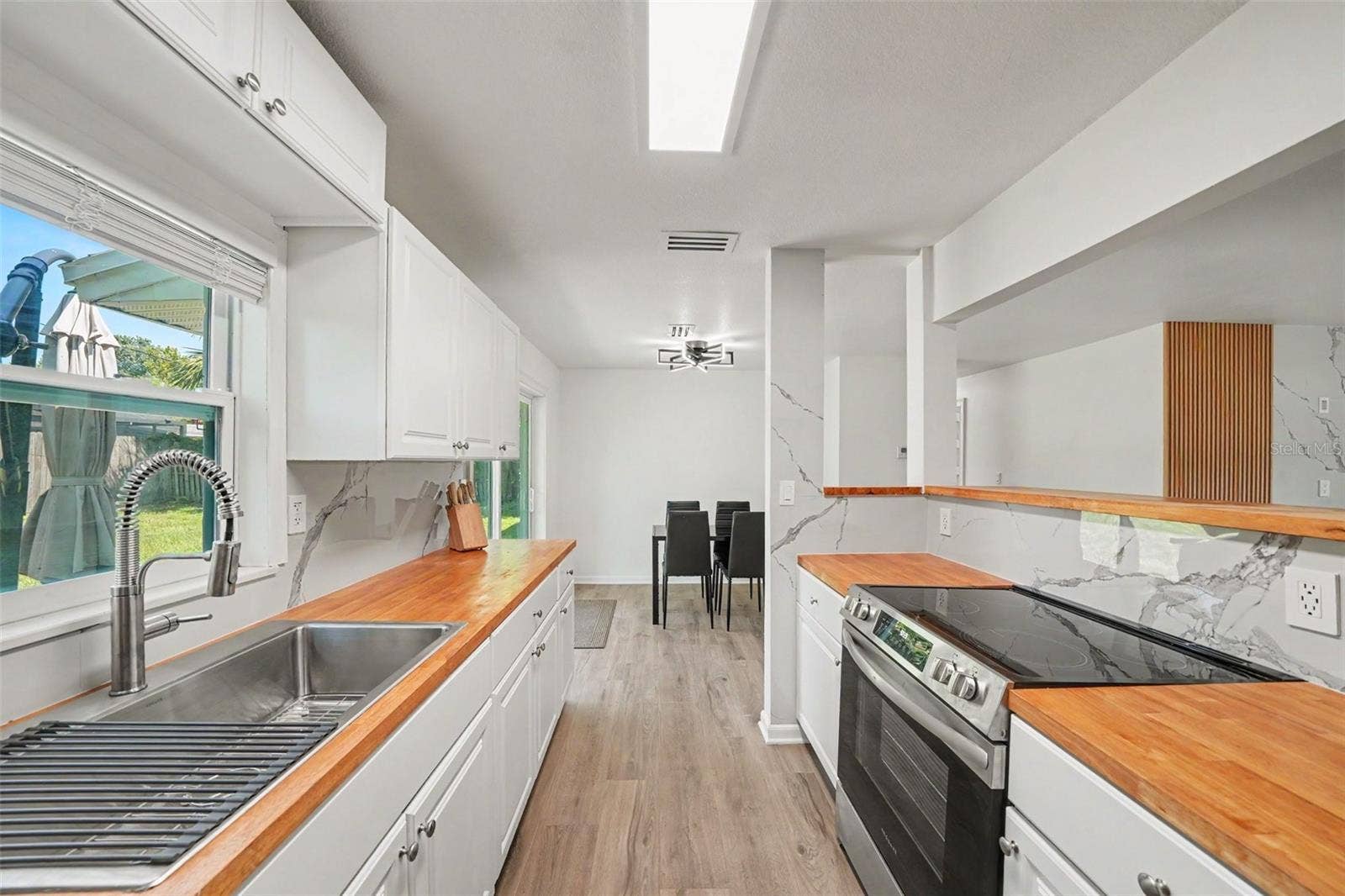 506 CAMBRIDGE CIRCLE, South Daytona, FL 32119 Kitchen has a nice window looking into the backyard. Very airy space.