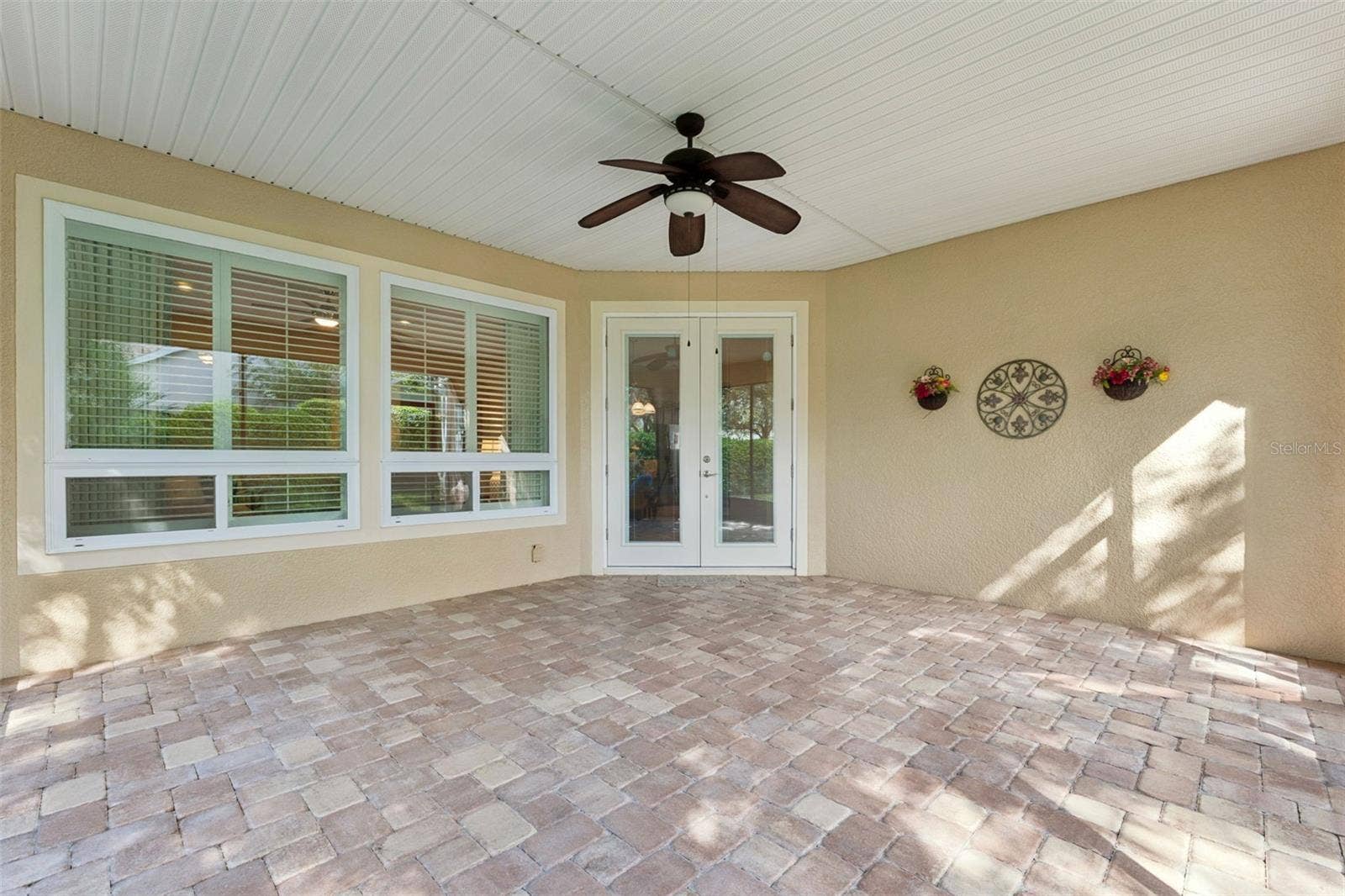 202 DRUMMOND LANE, Deland, FL 32724 Screen enclosed covered patio w/ a ceiling fan & a double French door entry into the home