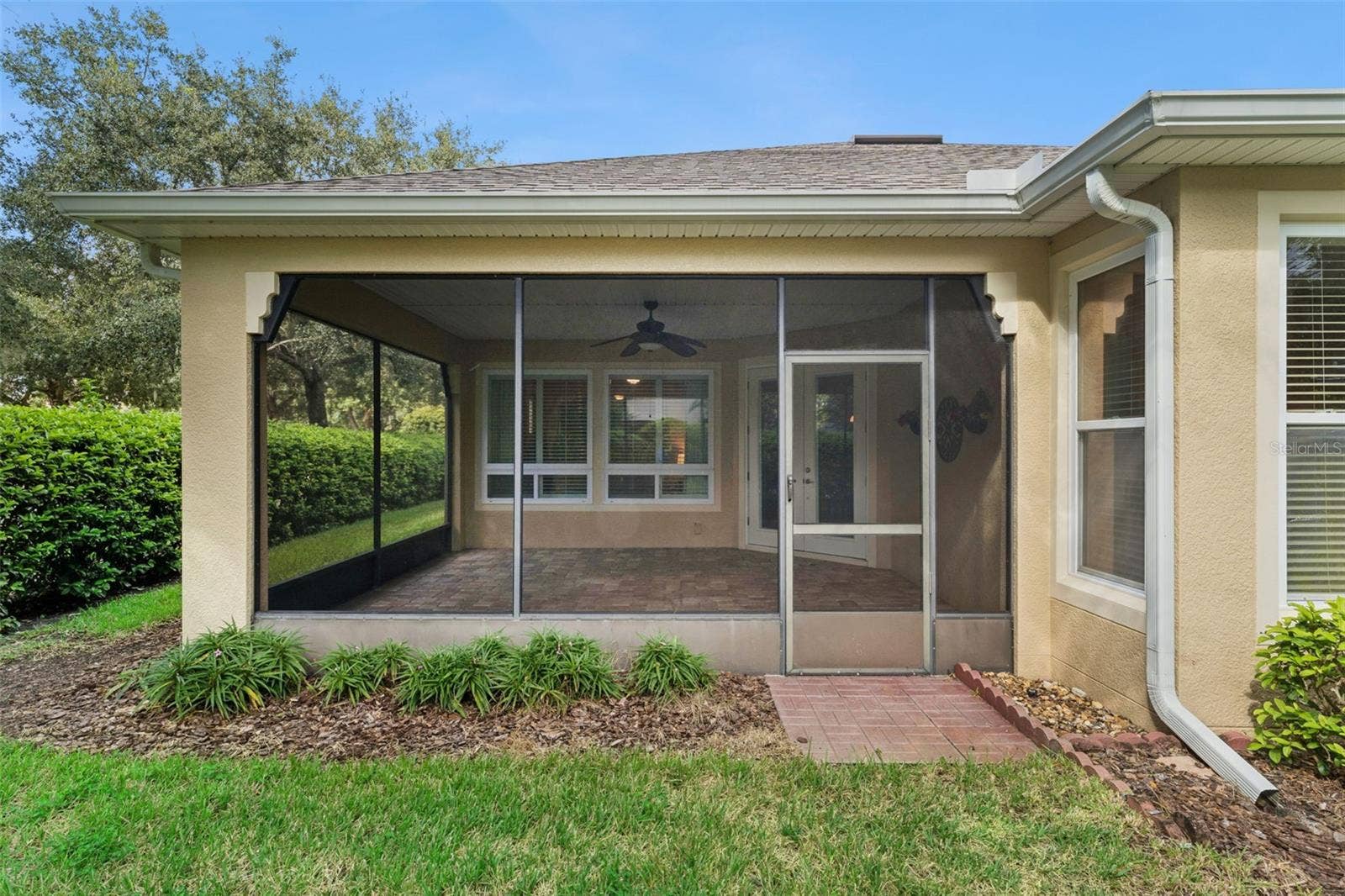 202 DRUMMOND LANE, Deland, FL 32724 View of the screen enclosed covered patio w/ gutter downspouts around perimeter