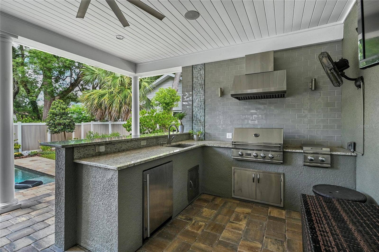 1951 WINTER PARK ROAD, Winter Park, FL 32789 Cooks will love the professional gas grill with hood, side burner, a deep sink, and loads of stone counter space. Grab a drink from the fridge while you are sitting by the pool!