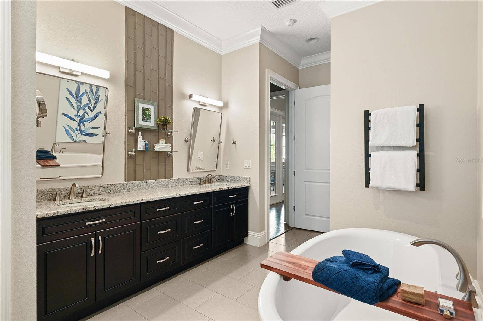1951 WINTER PARK ROAD, Winter Park, FL 32789 The master suite features 8-foot doors, a large linen closet, double sinks as well as dual shower heads and a hard-wired towel warming rack.