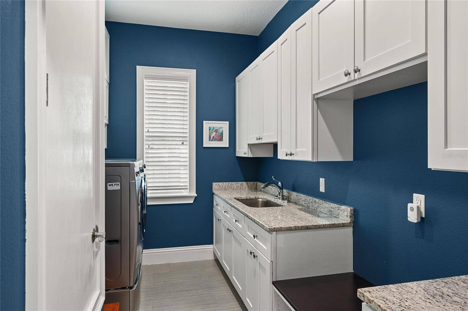 1951 WINTER PARK ROAD, Winter Park, FL 32789 Natural light fills the laundry area, complete with sink and an abundance of storage.
