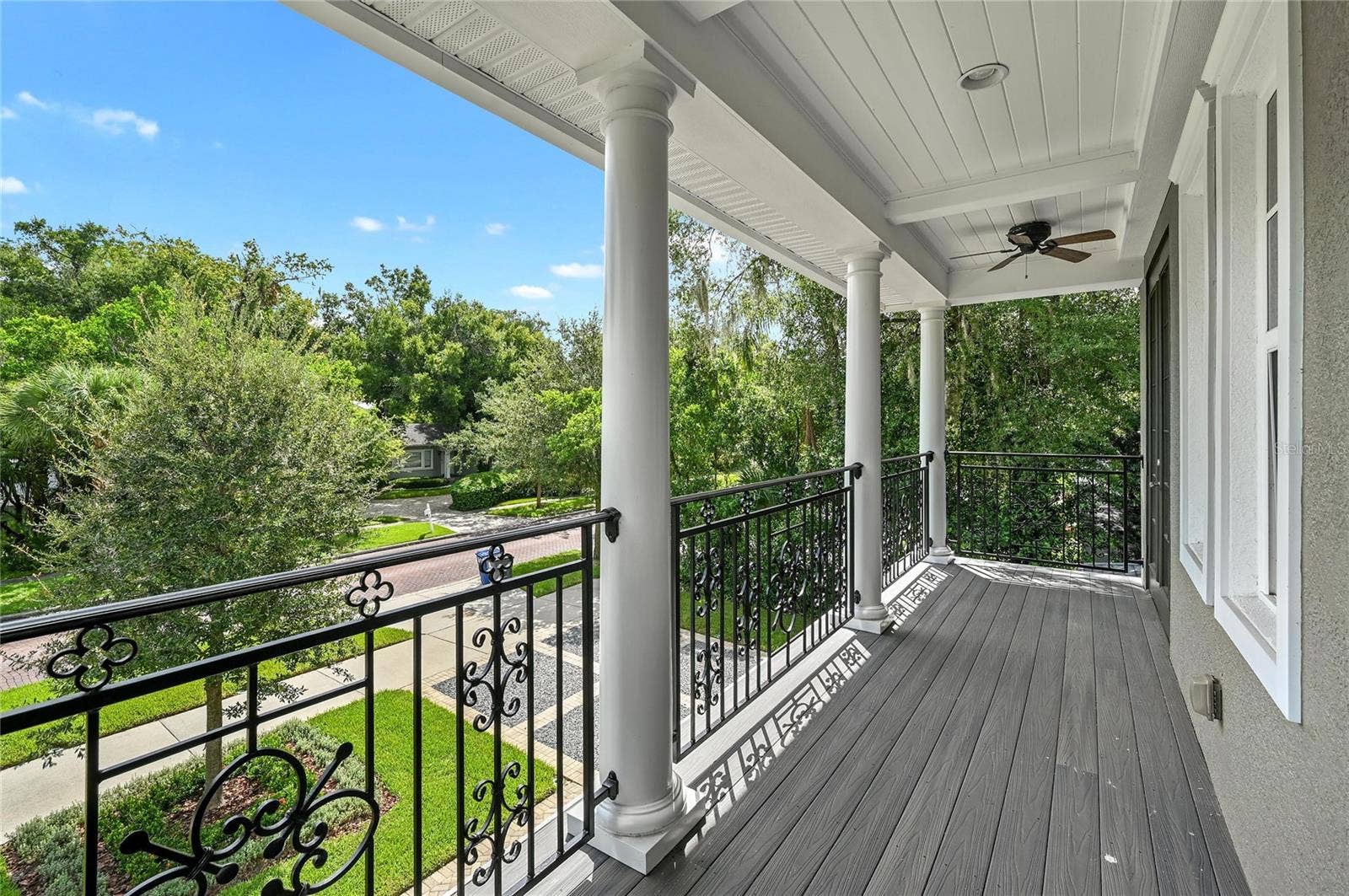 1951 WINTER PARK ROAD, Winter Park, FL 32789 The upper porch is a taste of Southern charm, complete with fans and iron-rail detailing.