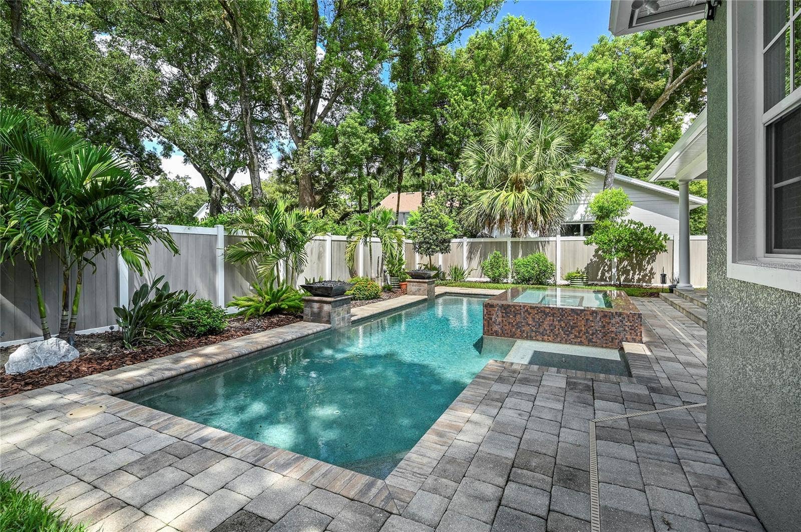 1951 WINTER PARK ROAD, Winter Park, FL 32789 The back of the home looks out to beautiful skies and a towering tree canopy.