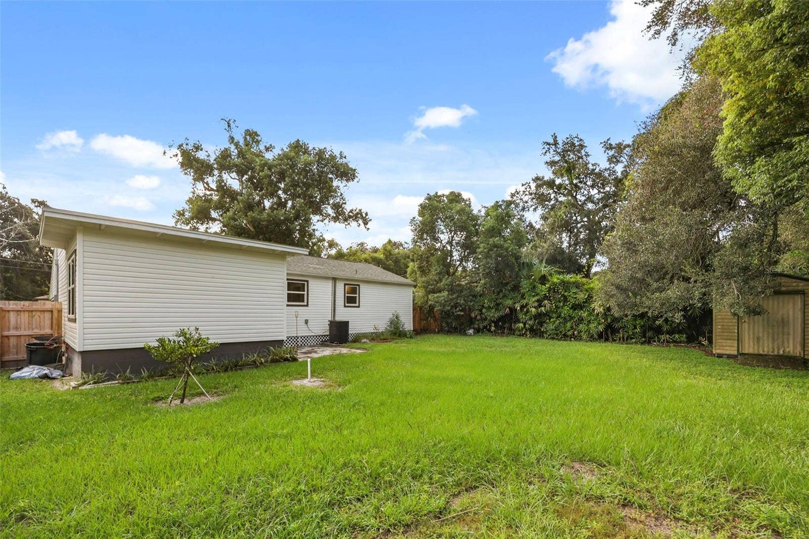 Fully fenced backyard with shed