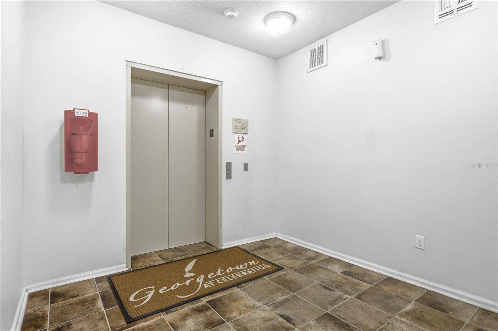 315 GRAND MAGNOLIA AVENUE, #312, Celebration, FL 34747 Elevator and stairs in building.