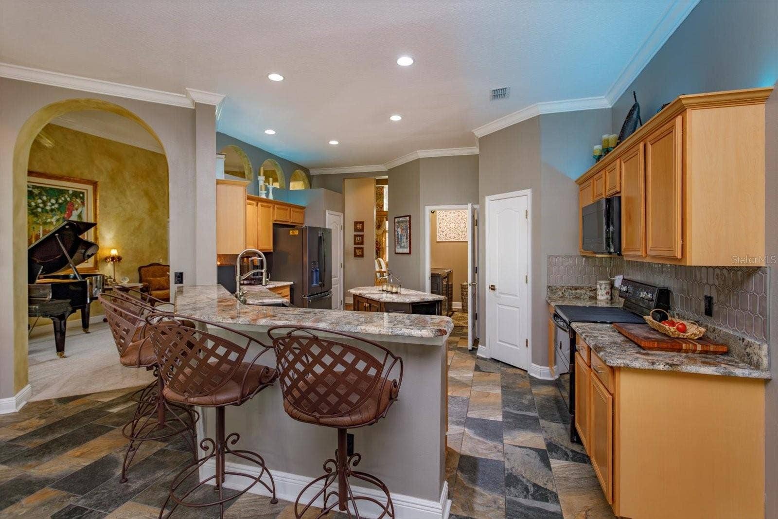 536 AVON GLADE PLACE, Sanford, FL 32771 Kitchen updated with rich granite countertops and slate look tile flooring
