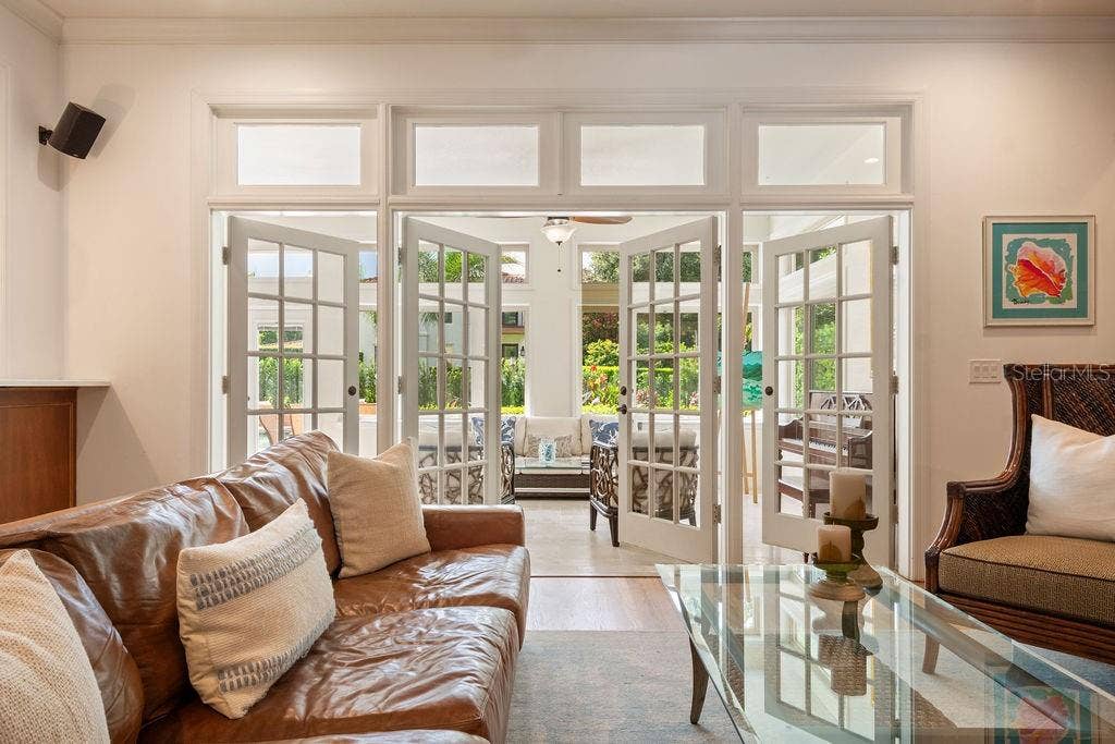 555 E LAKE SUE AVENUE, Winter Park, FL 32789 Family room leading to light and bright sunporch.