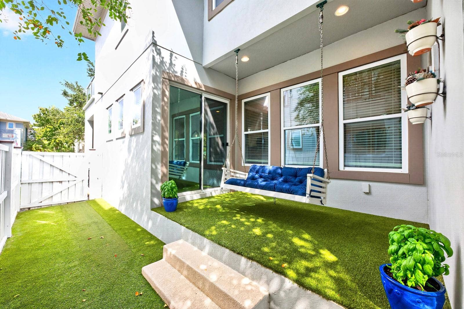 14061 WALCOTT AVENUE, Orlando, FL 32827 Low maintenance patio, privacy fenced sideyard finished with turf.
