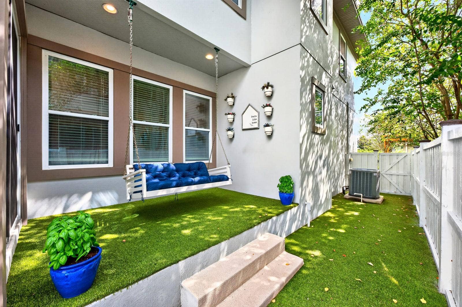 14061 WALCOTT AVENUE, Orlando, FL 32827 Low maintenance patio, privacy fenced sideyard finished with turf.